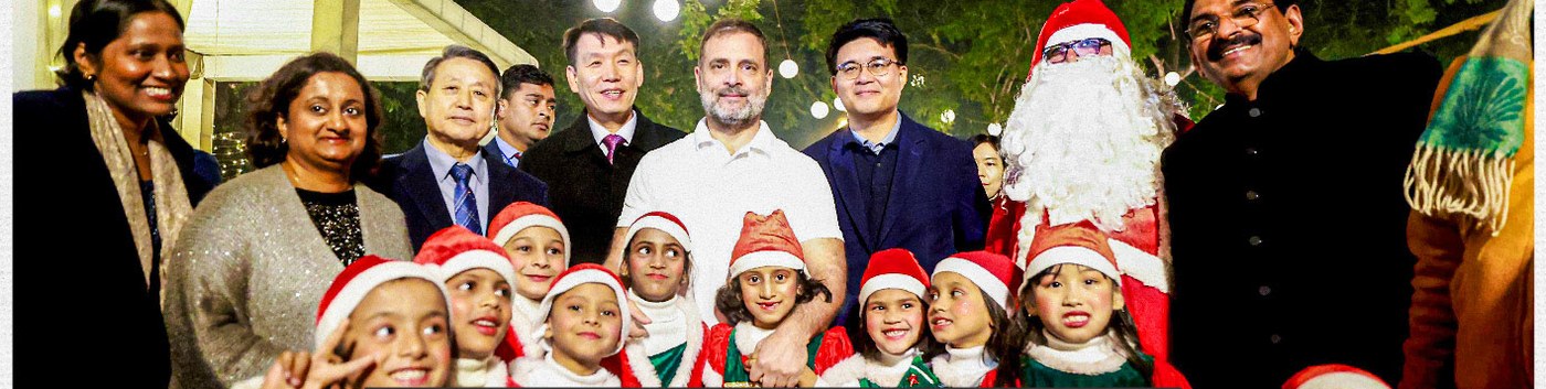Rahul Gandhi with children in Santa hats and members of the Indian Christians Parliamentarians Council at a Christmas celebration in Delhi